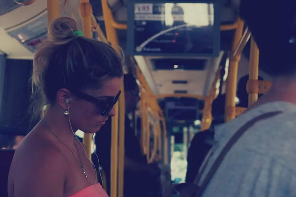 woman listening to music in bus